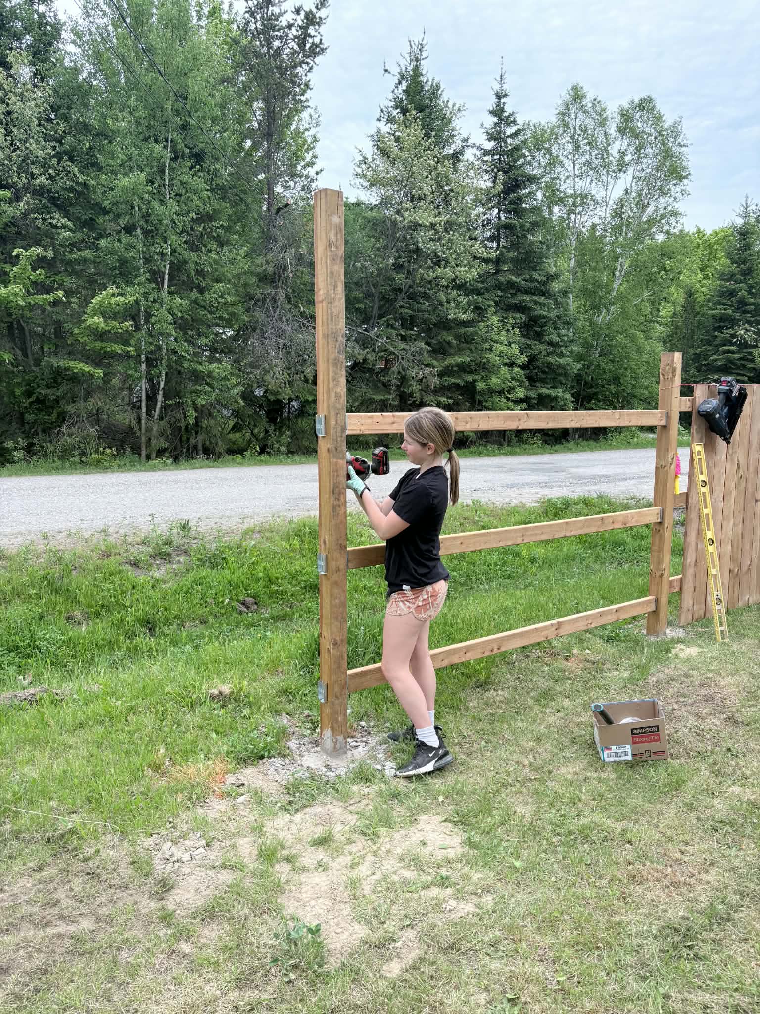 A wood fence and custom gate being built by PMK Construction
