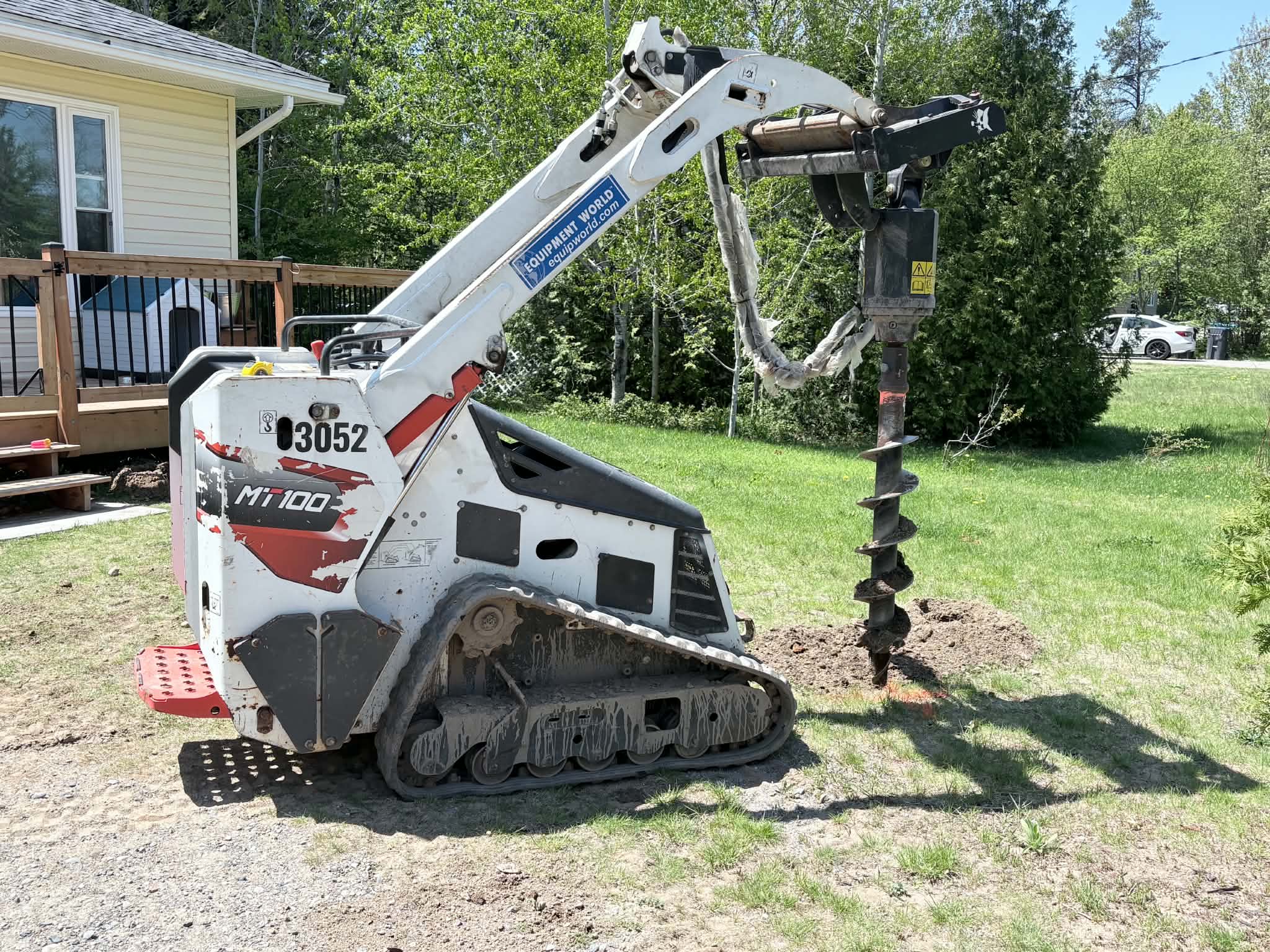 Post-hole equipment preparing a yard for a PMK fence installation